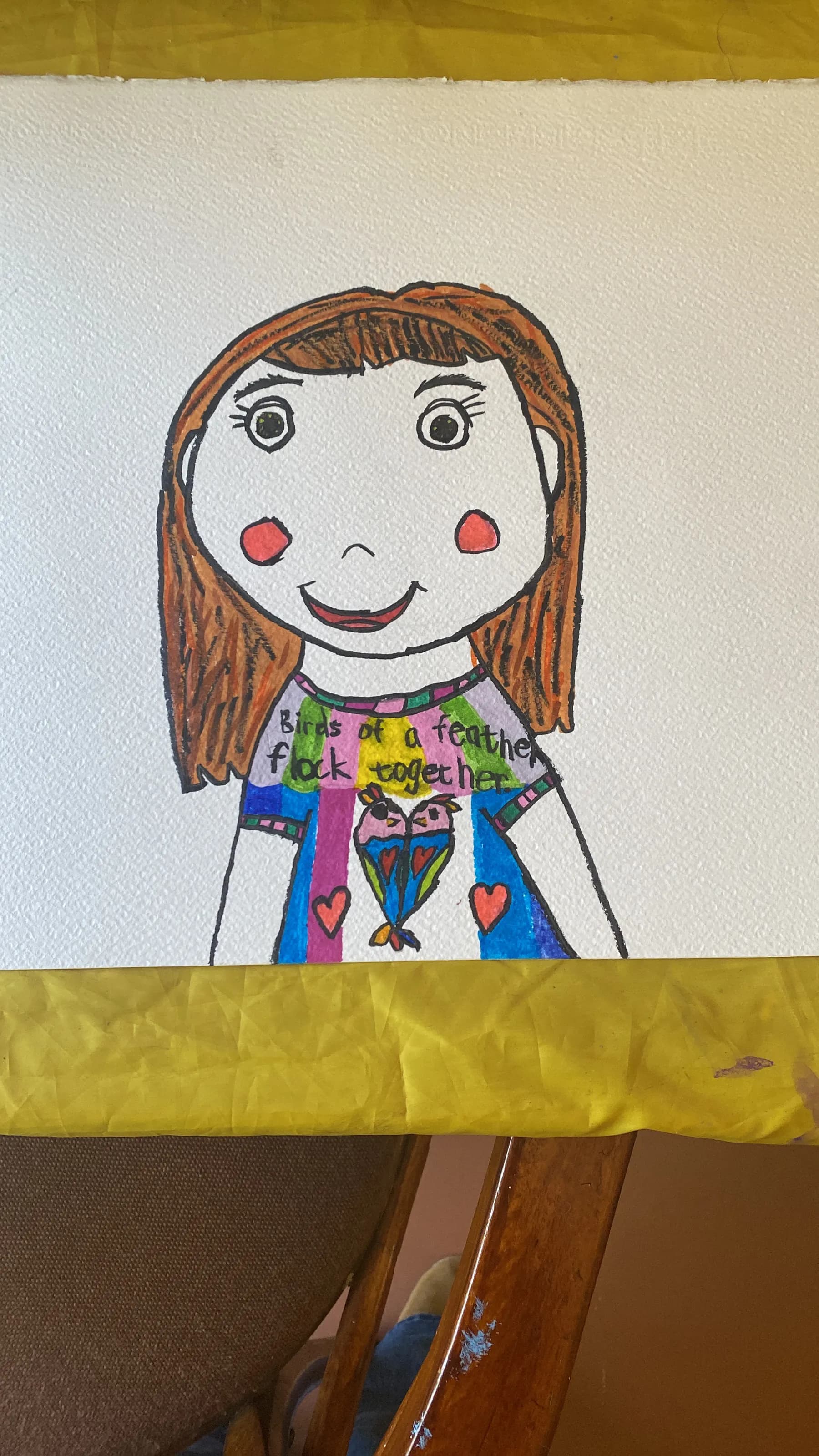 A child's hand-painted self-portrait on paper